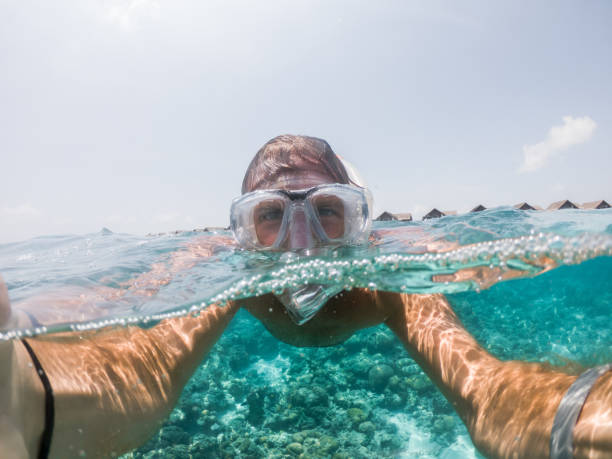 istock Young man takes selfie underwater with snorkelling mask 1311453509