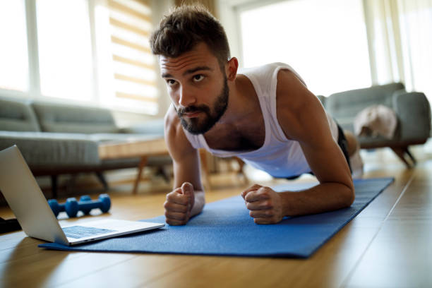 istock Young man exercising at home 1311454700