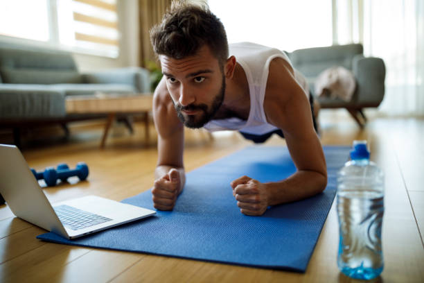 istock Young man exercising at home 1311454753