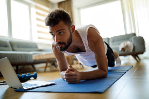 istock Young man exercising at home 1311454839