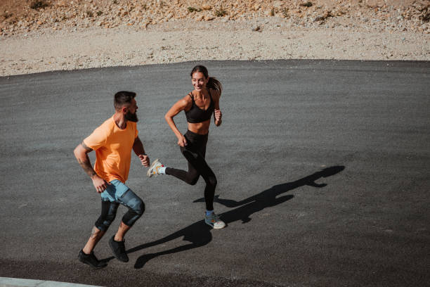istock Happy couple running outdoors in nature 1311457686