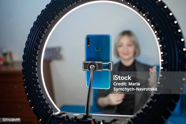 Woman Talking To Camera And Recording Video With Smartphone And Ring Light Lamp At Home Vlogger Stock Photo - Download Image Now