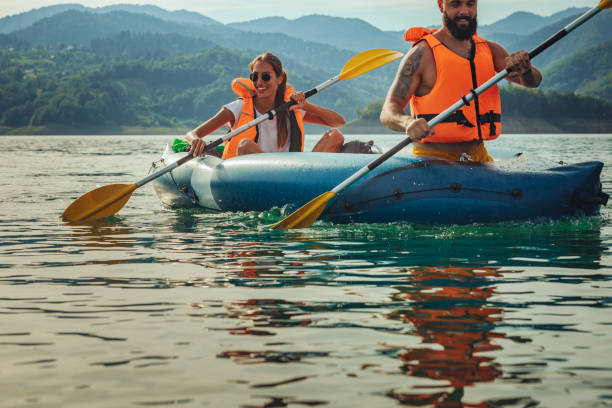 istock Couple in life jackets kayaking on lake 1311460447