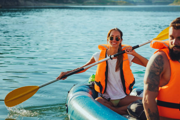 istock Couple in life jackets kayaking on lake 1311461105