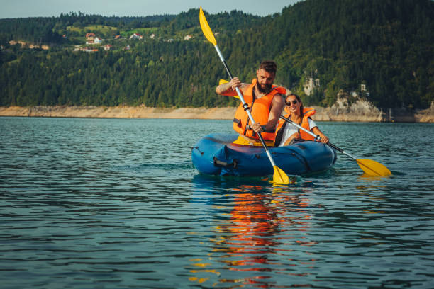 istock Lovely young couple on a kayak rowing 1311461309