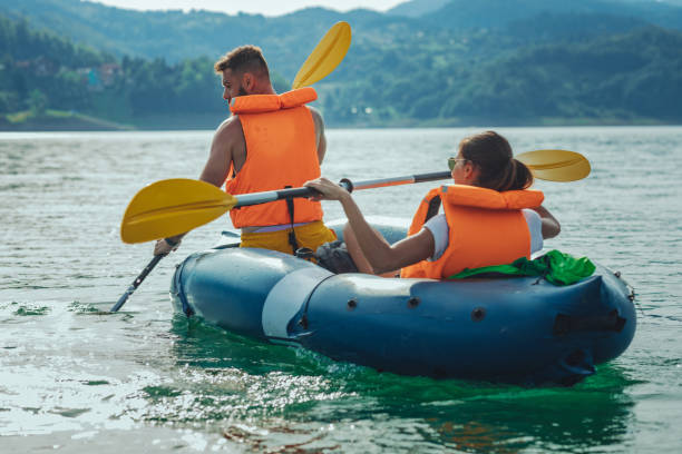 istock Man and woman kayaking on lake 1311461739