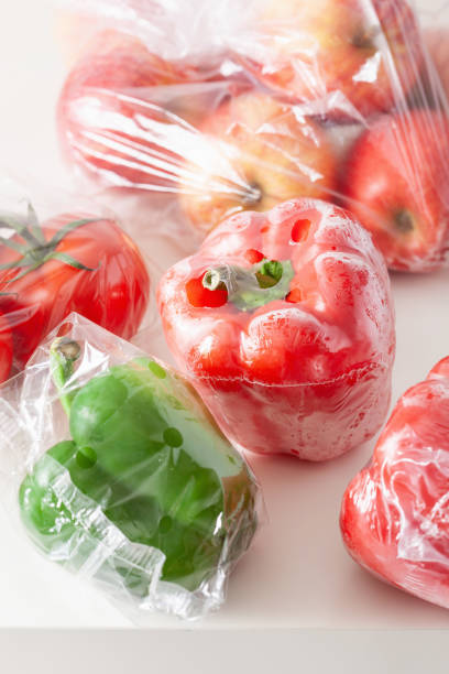 istock single use plastic packaging issue. peppers tomatoes apples vegetables in plastic bags 1311462035