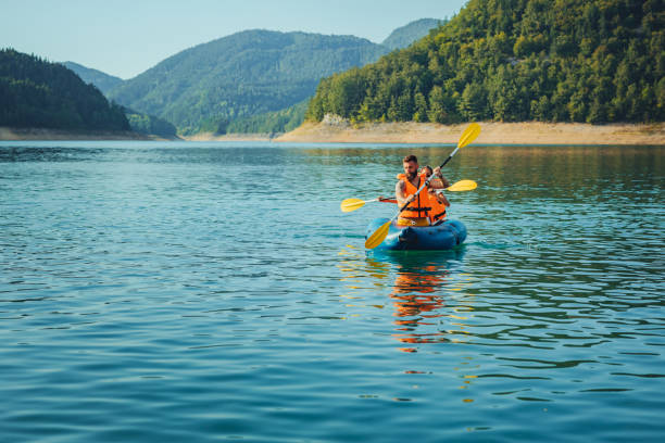 istock Young people kayaking together on a lake 1311462083