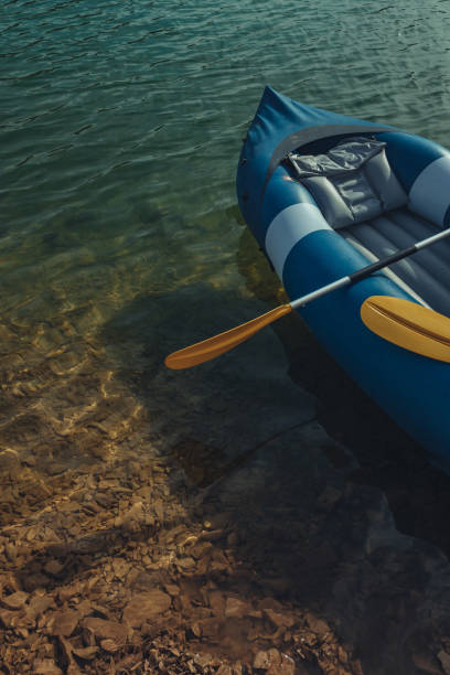 istock Rubber kayak and paddle floating on the water 1311462201