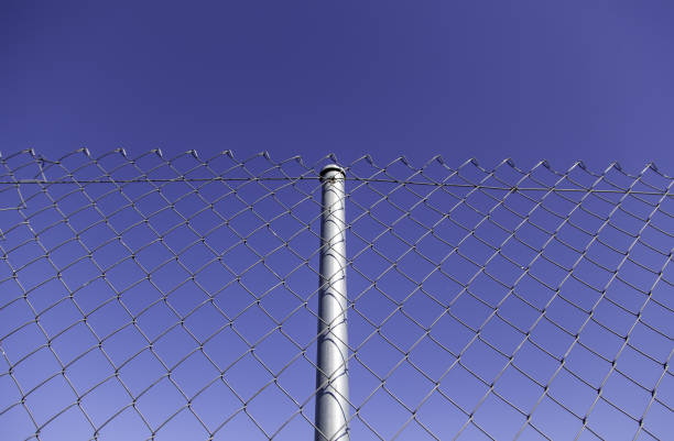 istock Metal fence with blue sky 1311462217