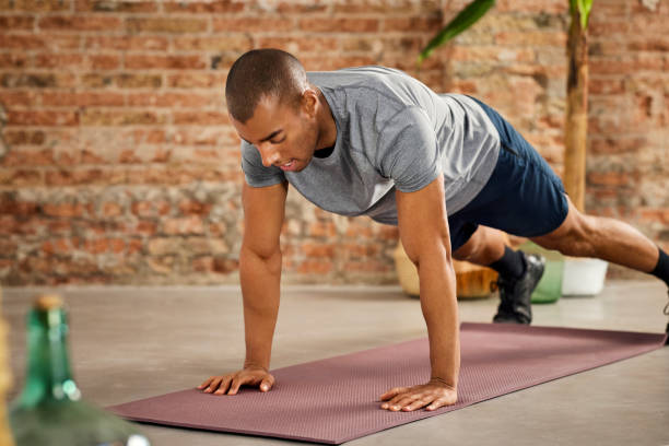 istock Young Male Athlete Practicing Push-Ups At Home 1311464308