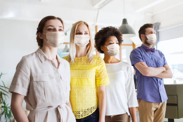 istock business team in masks in office 1311464365