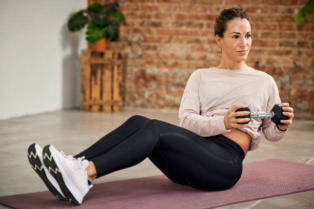 istock Female Athlete Exercising With Dumbbell At Home 1311464482
