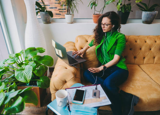 Green office space Businesswoman working on laptop in eco-friendly green office external hard disk drive stock pictures, royalty-free photos & images