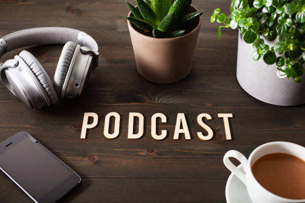 istock podcast word text concept modern wireless headphones smartphone 1311467344