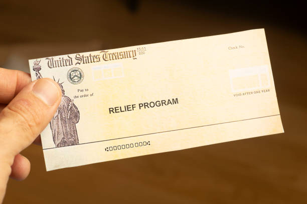 istock USA dollars background. American rescue plan, USA relief program, stimulus check and Act of 2021 concept. Money, business, profit and livelihood idea 1311468348