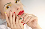 Multicolored makeup and  manicure.
