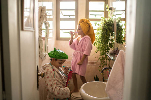 istock Sisters singing in the bathroom after bath 1311473163