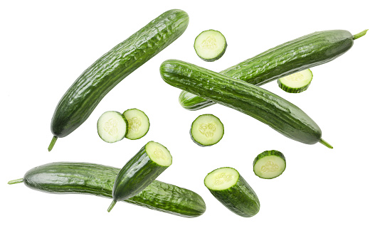 Cucumber whole and slices fly close-up on a white background. Isolated