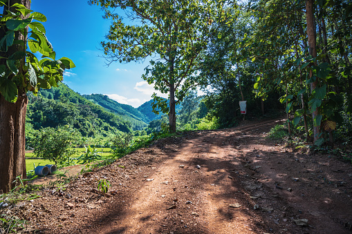 Countryside road with the view on the mountain in rural of thailand