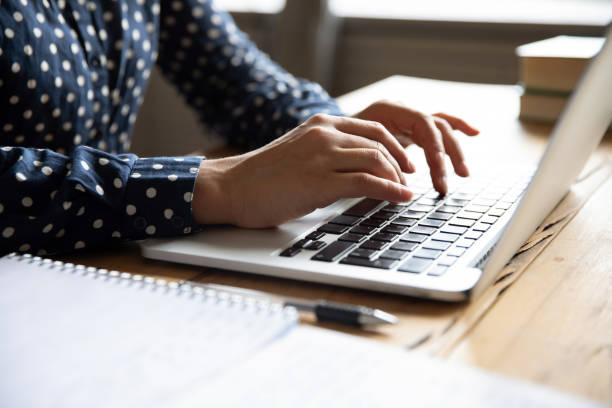 istock Close up view image female hands typing on laptop keyboard 1311475015
