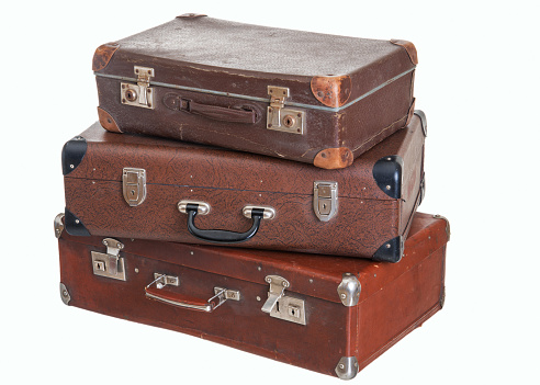 three old vintage suitcases of different size, isolated on white background