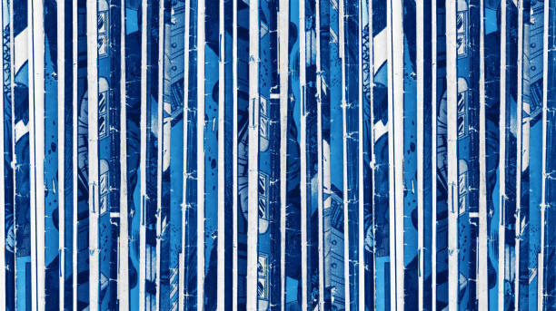 Old comic books stacked in a pile creates textured background pattern with blue monotone colors