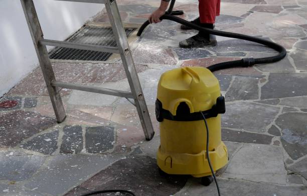 istock Man removes dirt with vacuum cleaner 1311482348