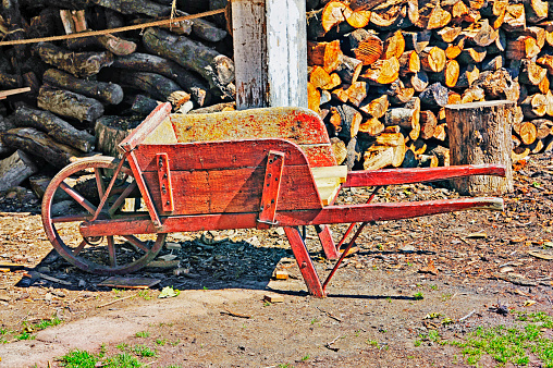 This old fashion wheelborrow is a handy tool for working outdoors and moving from one location to another without having to carry in our arms, for example carrying cut firewood.