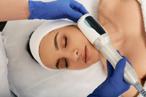 istock Cropped woman's face during facial Microvibration Therapy for correction oval face with a cosmetologist 1311483934
