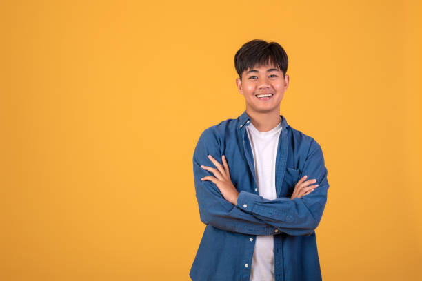 istock On orange background With a young Asian man Happy standing. 1311485010