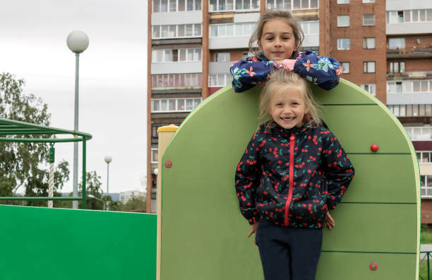 istock Two girls for a walk outdoors in the playground 1311485076