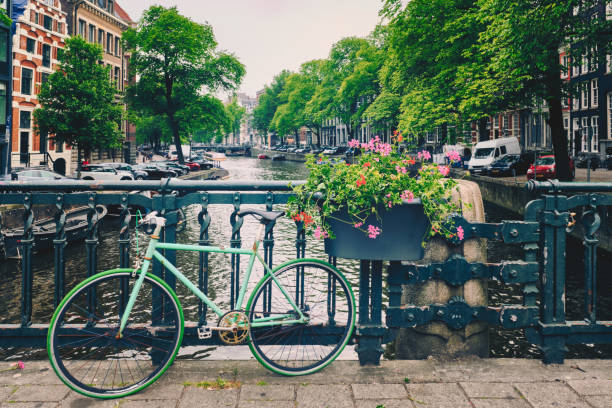 istock Amsterdam canal with boats and bicycles on a bridge 1311486074