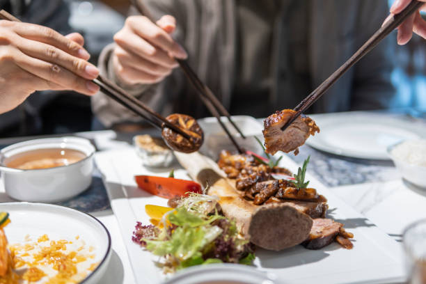 istock People eating roast beef with chopsticks 1311486416