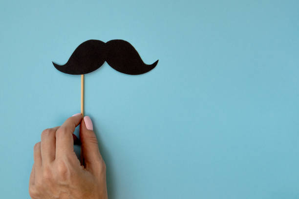 istock happy father day, mustache on blue background 1311486495