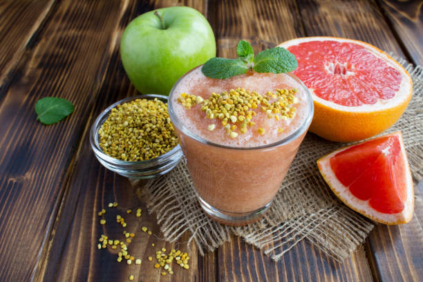 istock Smoothie with grapefruit, green apple and  bee pollen on the rustic wooden background 1311487464
