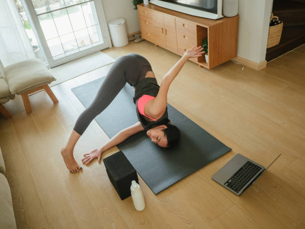 istock Asian female exercising at home. 1311489675