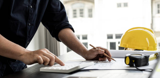 istock The home design architects are reviewing the house plan draft, the project commissioned by the client, and the custom design before delivery. Interior design and decoration ideas. 1311489740
