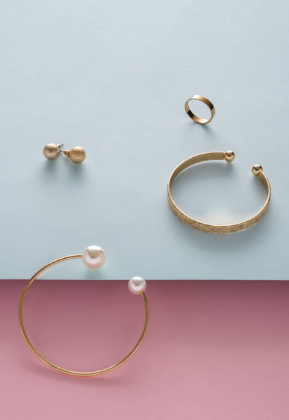 istock Golden jewelry set on pink and blue background with copy space 1311491649