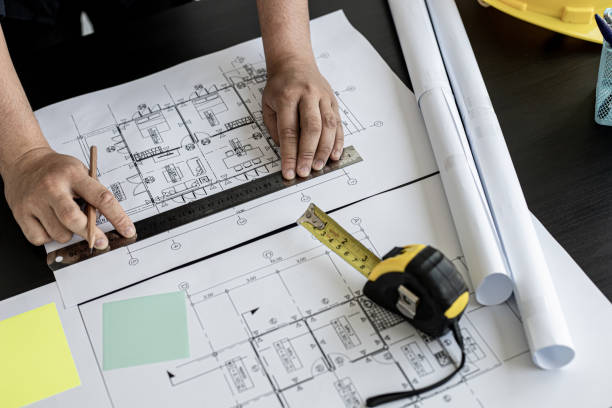 istock Home design architects are editing the drafts of the house plans, a project that was commissioned by clients and designed according to the requirements prior to delivery. Interior design ideas. 1311492898