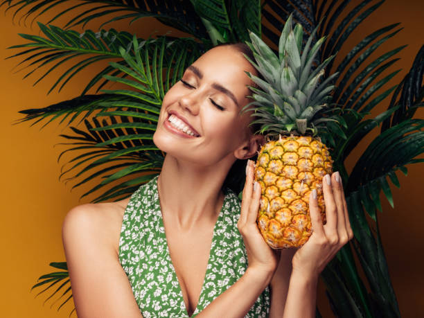 istock Beautiful girl with pineapple 1311493186