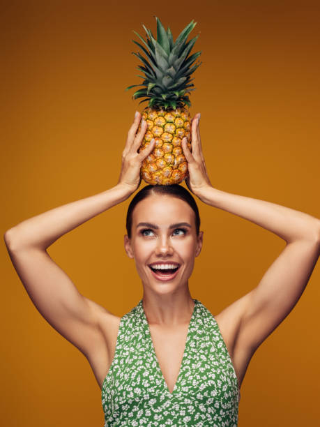 istock Beautiful girl with pineapple 1311493774