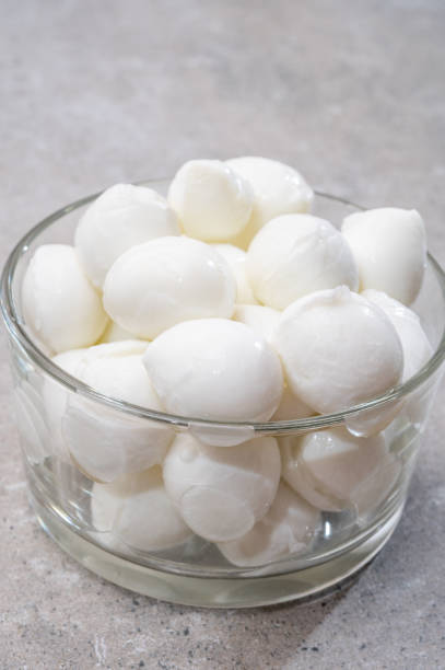 istock Cheese collection, small balls of fresh white soft Italian mozzarella cheese, ready for making caprese salad 1311495068