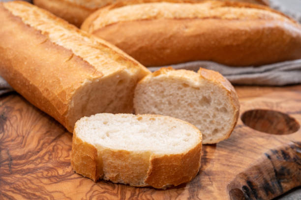 istock Ingredient for French breakfast, fresh baked crispy baguette white bread 1311496392
