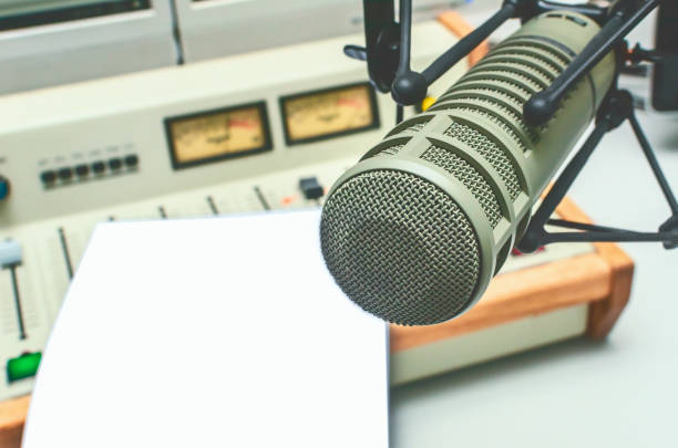 istock microphone, sound mixer and blank sheet of paper 1311496409