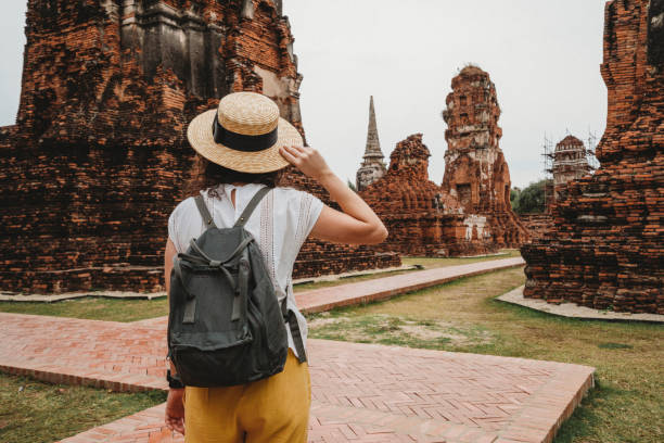 istock Young woman exploring a temple in Ayutthaya, Thailand 1311496647