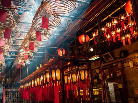 Man Mo Temple in Hong Kong with sun beams and incense