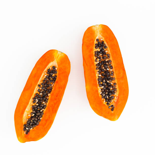 istock Two half of papaya fruit on white background. Flat lay. Top view. 1311498114