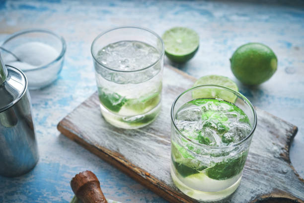 Hands holding mojito drinks