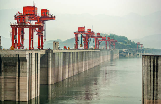 istock Up-river shot on Three Gorges Dam with red cranes, China. 1311499459